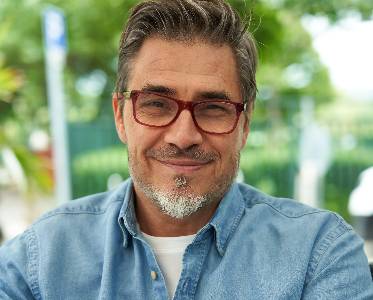 Middle-aged man smiling.